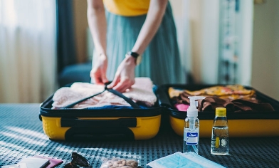 a person packing a suitcase