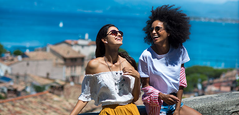 Two persons in a seaside village enjoying the sunshine