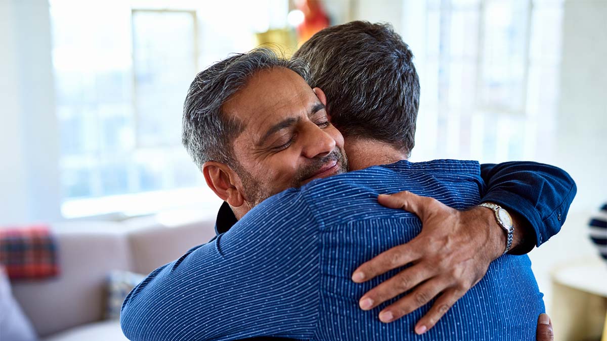 Two people hugging each other