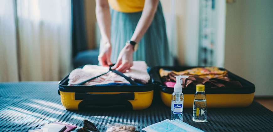 a person packing a suitcase